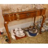 An early 20th century walnut side table, slightly serpentine, cabriole legs, shells to knees,