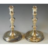 A pair of silver table candlesticks, reel sconces, dished bases, 19.5cm high, London 1976