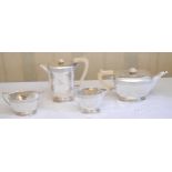 A silver four piece tea service, of angular boat form, engraved with a band of scrolling foliage,