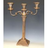 A silver three light table candelabrum, detachable incurved canted square beaded nozzles and drip