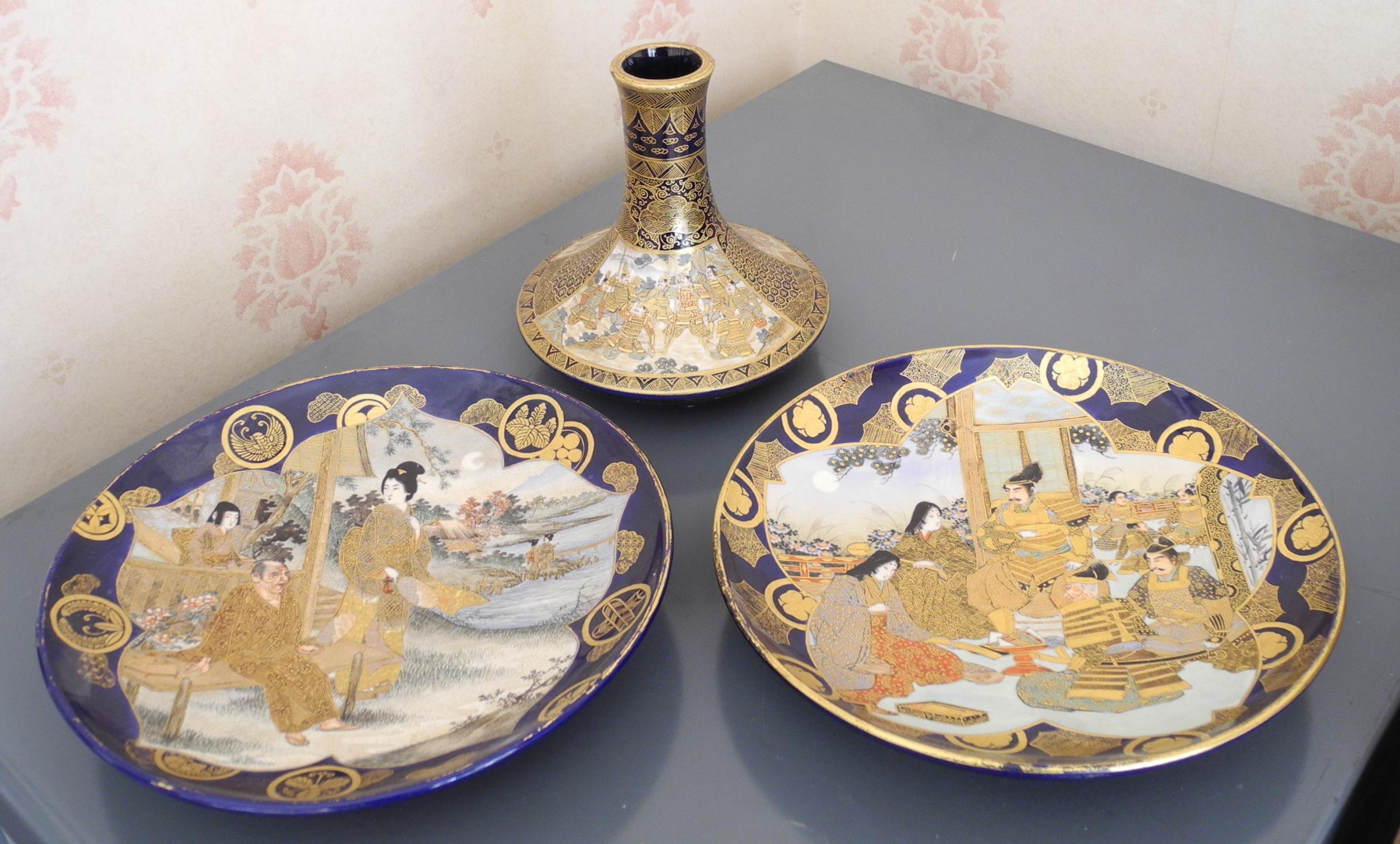 A pair of Japanese satsuma circular plates, decorated with geisha and elder in shaped reserve on a