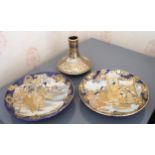 A pair of Japanese satsuma circular plates, decorated with geisha and elder in shaped reserve on a
