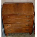 An early 20th century walnut bureau, the fall front above four graduated cockbeaded drawers,