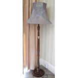 An early 20th century oak standard lamp, fluted, marbled blue shade