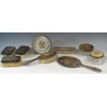 A four piece silver backed dressing table set, comprising hand mirror, hair brush, clothes brush,