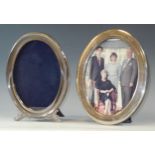 A silver oval easel photograph frame, 22cm high, Sheffield 1986; another, plated (2)