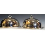 A pair of E.P.N.S meat domes and stands, gadrroned borders, 39cm wide