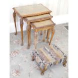 A 20th century rectangular foot stool, cabriole legs, c.1930; a nest of three walnut tables, leafy