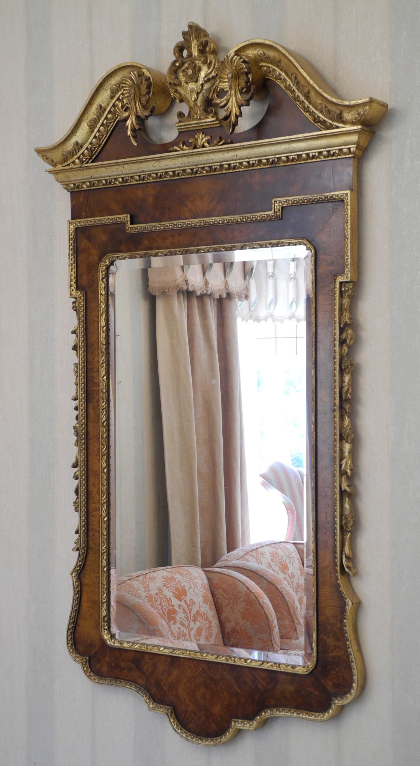 A George II style walnut and parcel gilt wall mirror, rectangular bevelled plate within gilt