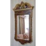 A George II style walnut and parcel gilt wall mirror, rectangular bevelled plate within gilt