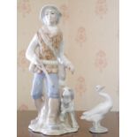 A Lladro model, of a goose, 12cm high, printed mark; a Tengra figure, of a hunter and his dog,