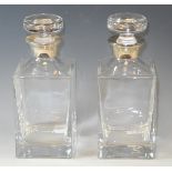 A pair of silver mounted square clear glass decanters with mushroom shaped stoppers, 22cm high,