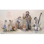 A Capo-di-Monte figure, modelled Volta, The Tramp, 29cm high; others, Clown Cello Player; Mother and