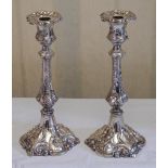 A pair of plated candlesticks, detachable nozzles, panelled campana shaped sconces, the bases cast