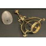 A Victorian brass pendant light fitting, shaped scrolling foliate and dragon mask arms, crowned