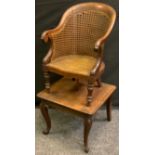 A Victorian mahogany child's combination high chair and table, curved back terminating in scroll