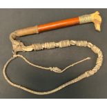 An early 20th century hunting/beagle whip, carved bone whistle handle as a dogs head, embossed