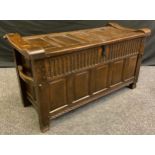 A 20th century Nigel/Rupert Griffiths style oak blanket chest, five panel top, carrying handles,