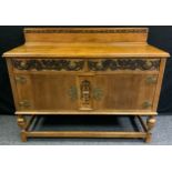 A 20th century oak sideboard, shaped half gallery, rectangular top above, two short drawers and