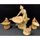 A Royal Dux figure, of a lady seated on an oversize shell, in typical tones, 33cm high, printed