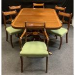 A reproduction mahogany twin pedestal dining table, rounded rectangular top, turned supports, lion