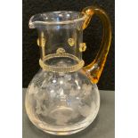 A Victorian amber and clear engraved glass jug, possibly James Powell & Sons, moulded floral collar,