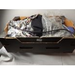 A box of various items to include belt, tops/jeggings etc...