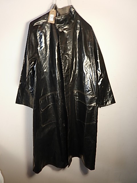 A black rain coat C. 1970's? labels unreadable, small tear in left arm.