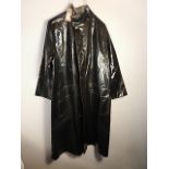 A black rain coat C. 1970's? labels unreadable, small tear in left arm.