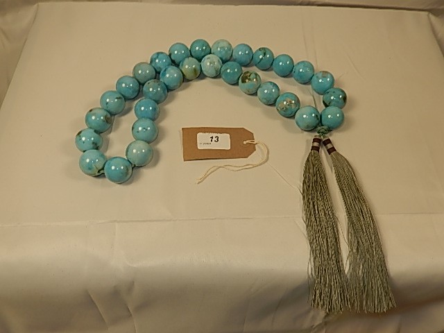 An Oriental style set of heavy turquoise beads by Oka interior company