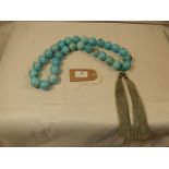 An Oriental style set of heavy turquoise beads by Oka interior company