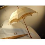 A 1920's sun parasol with wooden handle in original bag from shop - Derry and Toms Kensington London