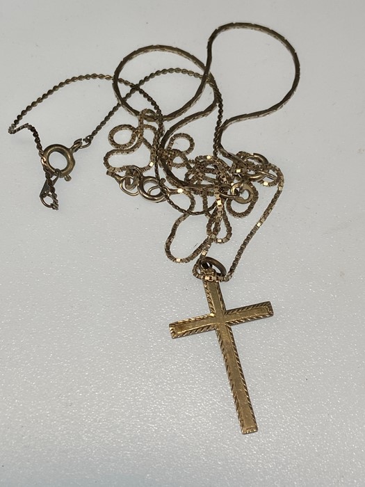 two silver chains with crucifix