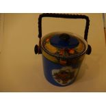 A vintage china biscuit barrel with wicker handle with fruit in basket decoration ( 16 cm high )