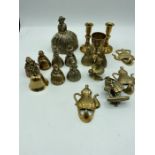 A collection of: brass bells; brass hooks; brass door knocker; miniature candlesticks and challis