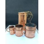 Four copper graduated measuring cups and three graduated copper and brass miniature tankards