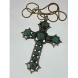 A large turquoise stone cross pendant necklace