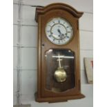 Modern Oak Cased Wall Clock with key and pendulum ( ticking and working at time of lotting )