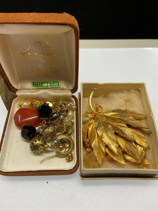 Two boxes to include a gilt brooch with matching earrings; and second box of various earrings and
