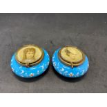 A pair of blue glass enameled pill boxes with glass lids with portraits of young women, A/F - some