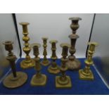 collection of brass candle holders