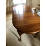 Mahogany extending dining table with 2 leaves. Winding mechanism is missing and table is fixed in