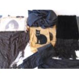 A box of Various black items, including a fringed shawl, two hand made fabric panels with a black