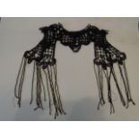 A Victorian/Edwardian black beaded collar with 'stud fastening' and fringing, Some beads are missing