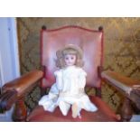 A vintage composite bisque faced doll marked '11' fully articulated with brown sleepy eyes. Possibly