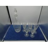 Floral design cut glass decanter and 5 matching glasses. Decanter 13 inches tall including stopper
