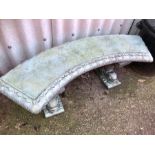 Curved concrete garden bench with fish supports