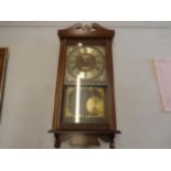 cased wall clock with pendulum