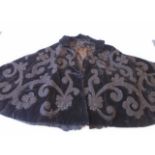 A Black Velvet quilted Victorian mourning cape embellished with applique bead trimmed work.