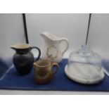 collection of jugs and a cheese dome